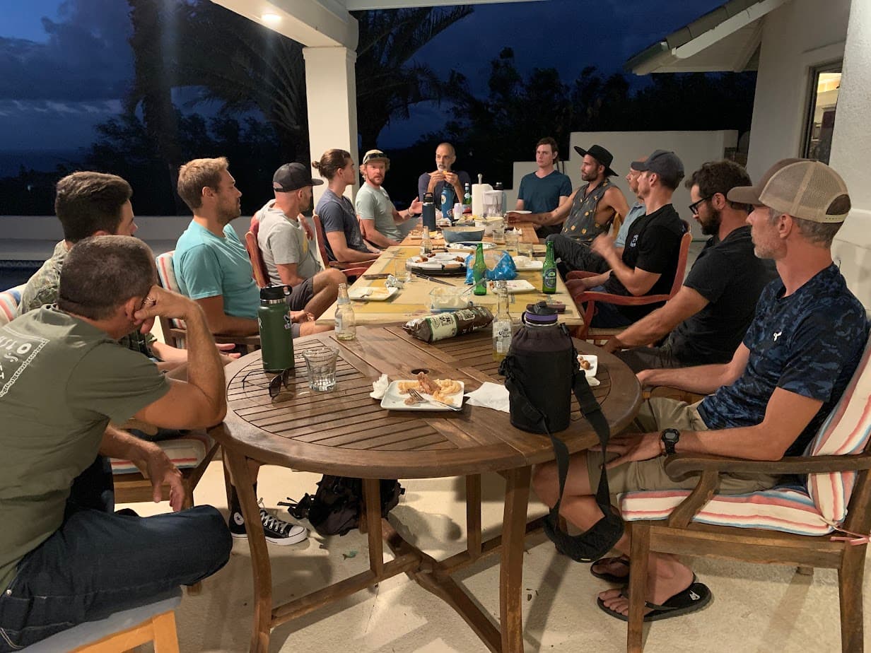 Men gathered around a table for a Brotherhood conversation